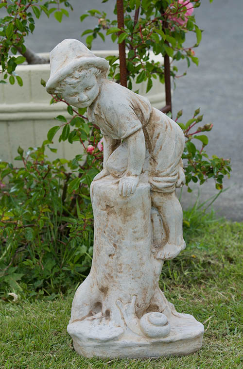 The Faraway Garden Boy with Snail is a small statue depicting a boy climbing a log to escape from a snail. A delightful addition to any garden setting and looks great in our sepia wash for an aged effect.