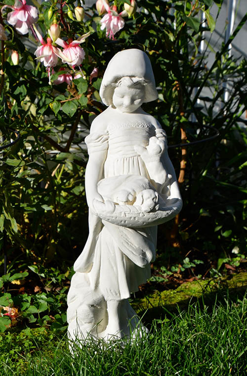 The Faraway Garden Girl with Puppies is a smaller statue depicting a girl looking down at a basket of puppies she's holding. A delightful addition to any garden setting and looks great in our sepia wash for an aged effect.