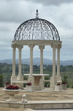 The Faraway Garden Gazebo or Belvedere is an impressive architectural structure that will add statement artistry to a garden setting. Comprising of six columns on pedestals with interlinking seating, topped with an ornate steel dome it creates a stunningly romantic place and can be incorporated into a design scheme to draw the eye towards a key focal point.&nbsp;

Historically gazebos were built to provide advantageous views of the surrounding areas and were common in Egyptian gardens 5,000 years ago.