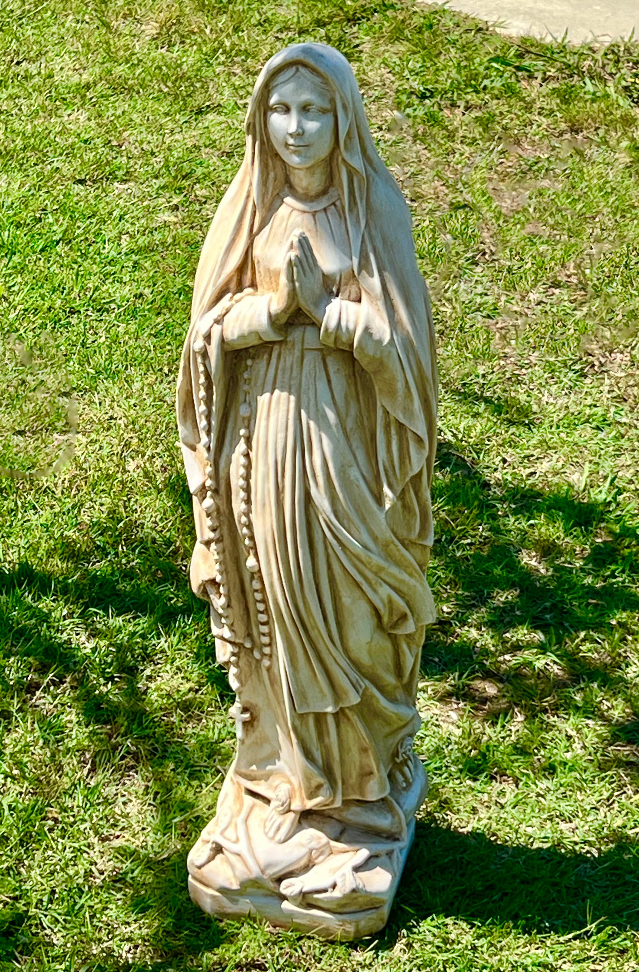 The Faraway Garden Mother Mary is a graceful garden statue depicting the Virgin Mary, our blessed Mother of Jesus Christ. She works wonderfully raised on a pedestal in a formal flower bed, as a water feature in a pond or nestled in an herbaceous border. Choose a sepia wash for an aged effect to define her detail.