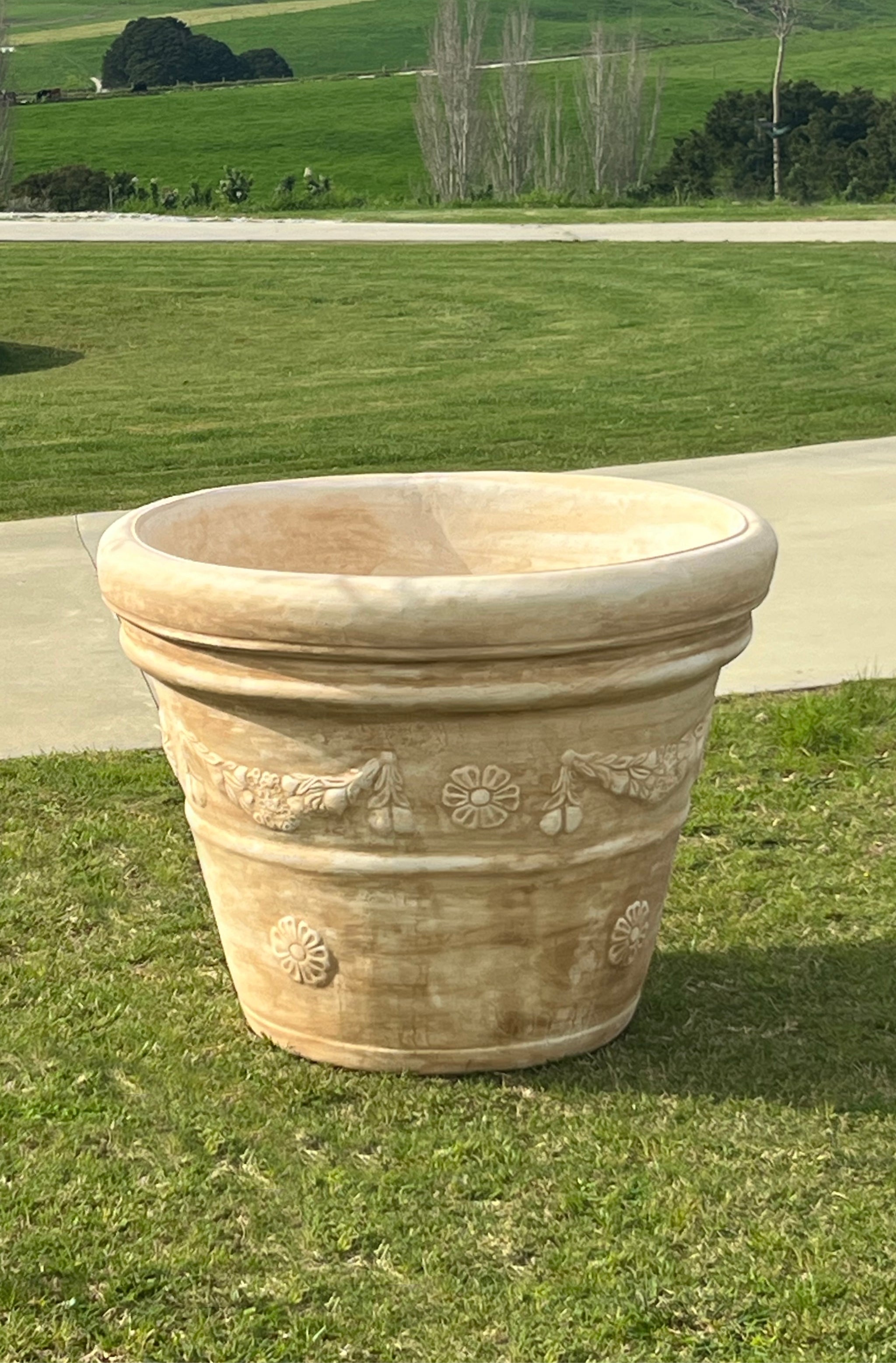The Faraway Garden Mondo Pot is a large, elegant garden planter inspired by the classical Italian aesthetic with distinctive moulding around bowl and linear detailing on a generous rim.

This impressive garden planter looks stunning as part of a group or row; or as a focal point at the end of a walkway or as a pair flanking an entrance. An ideal planter for ornamental trees.

This pot is part of the Phoenix Italia collection and can have the traditional sepia wash for an aged effect (as pictured).